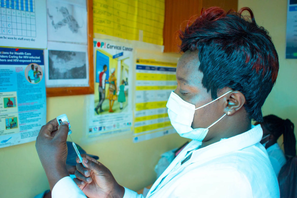 CFK Africa masked doctor holding syringe